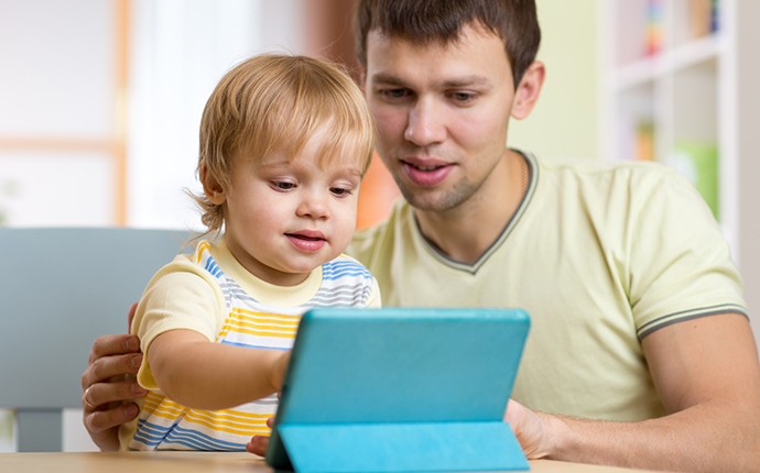 Man and child on tablet Man and child on tablet