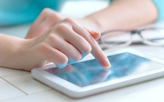 Take our survey Hand with tablet