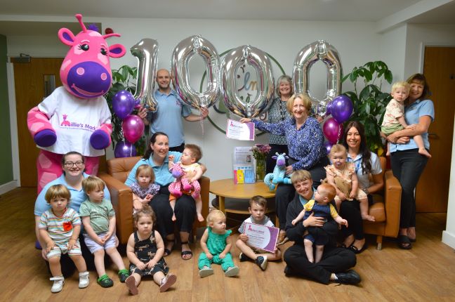 Children and staff at Elm Cottage Nursery Brookfield celebrating with Mary Robinson MP, Dan Thompson from Millie's Trust, Gail Murphy from NDNA and Millie Giraffe